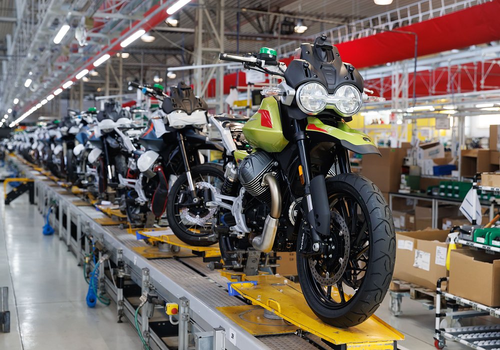 partially assembled motorcycles on the assembly line in the well lit factory