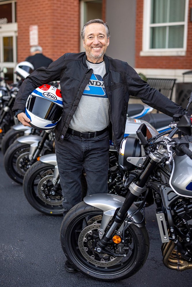 Freddie Spencer poses with his iconic helmet before a line of CB1000Fs.