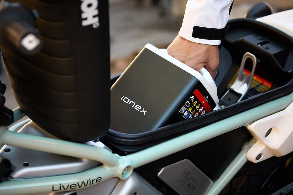 Dustin removes an Ionex swappable battery from the Honcho's under-seat bay.