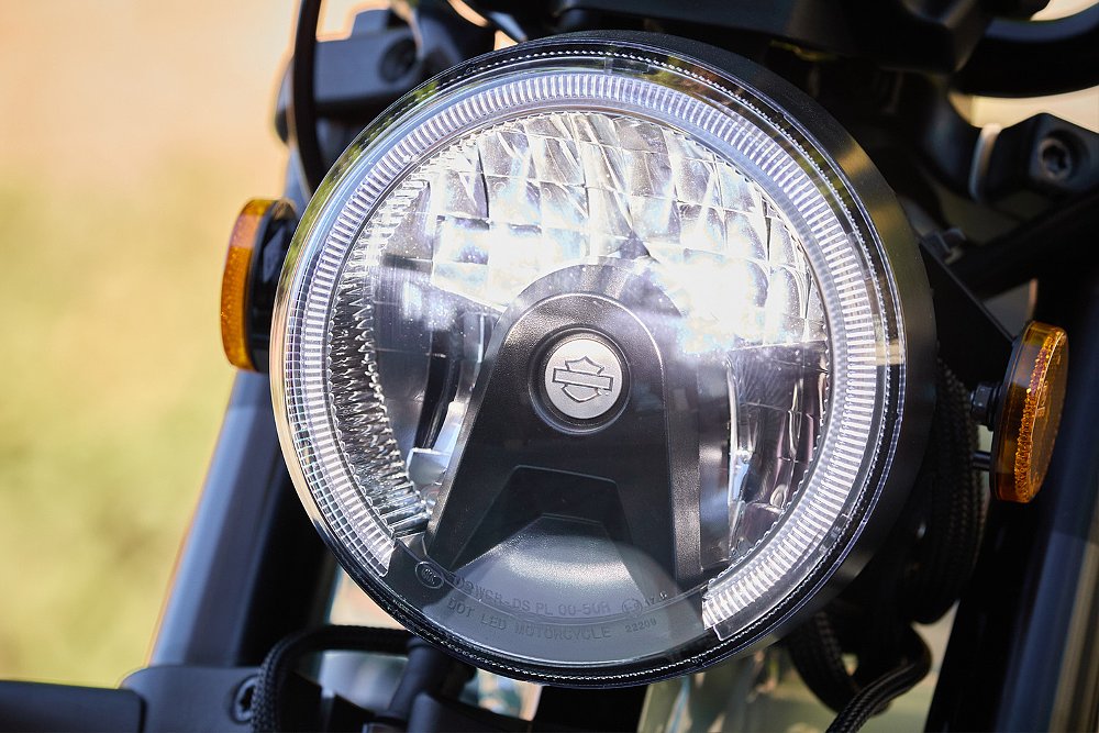 A close up of the Harley-Davidson-branded headlight on the Honcho Street.