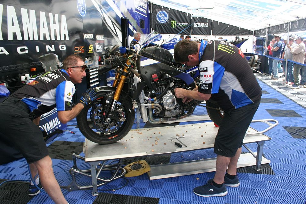 mechanics work on Josh Hayes' motorcycle