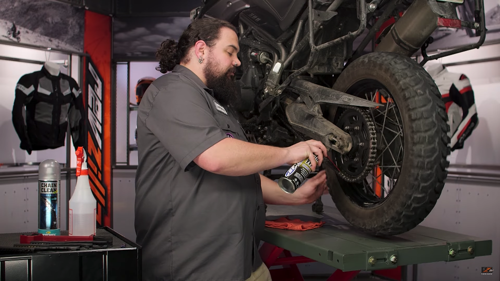 Lemmy waxes a motorcycle chain