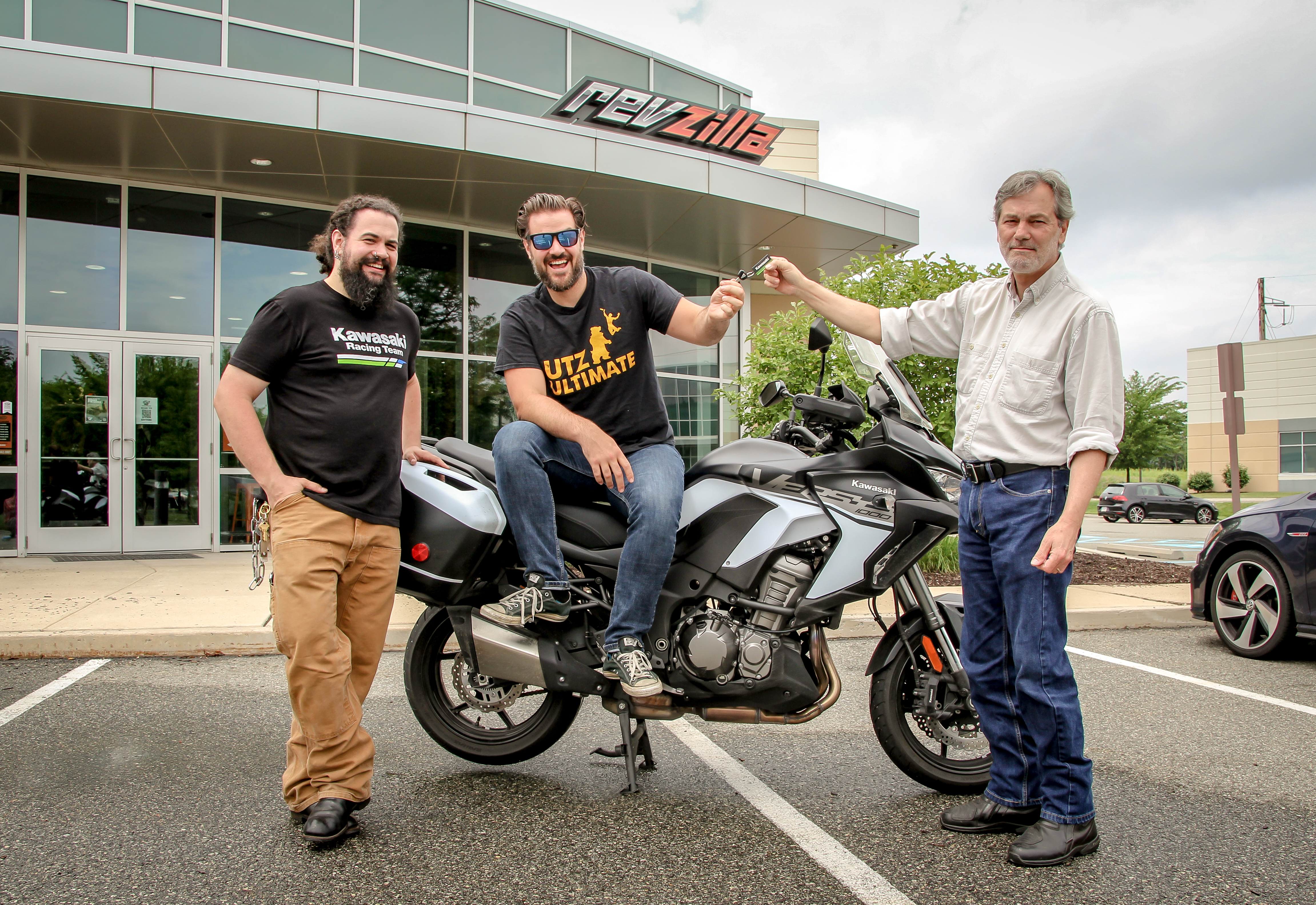Lances hands off the keys of the Versys to Lemmy and Spurgeon