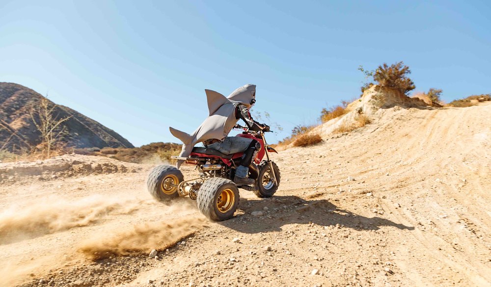 Zack takes a run at the hill on a borrowed three-wheeler