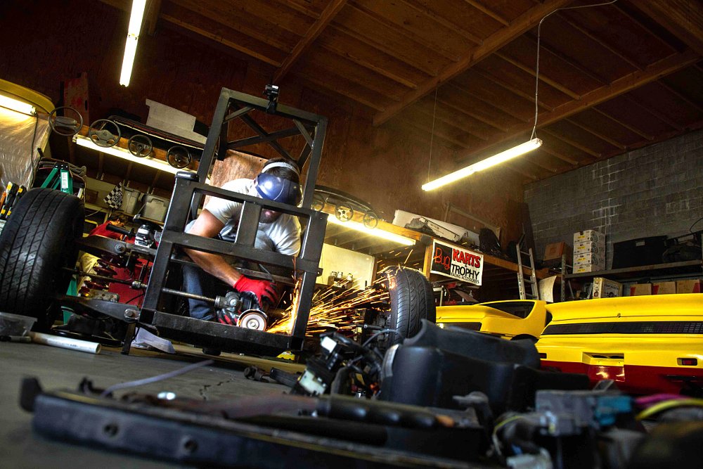 working in the shop on the three-wheeler