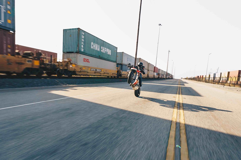 ducati streetfighter wheelie near train tracks