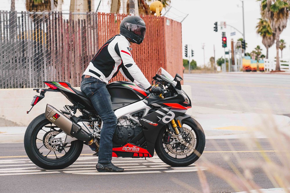 Aprilia RSV4 1100 waiting at stop sign with rider