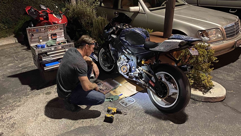 working on a Suzuki GSX-R1000 in a motel parking lot