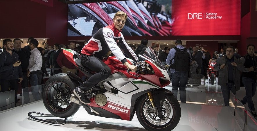 Chaz Davies sits on a Ducati at the EICMA show