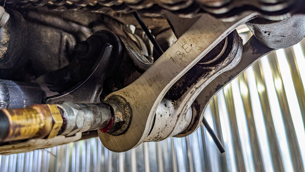 Lubricate dirt bike linkage with grease gun