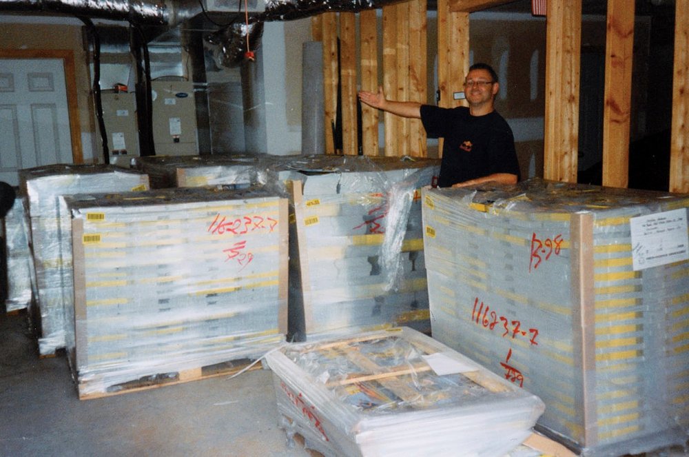 Christian Neuhauser with stacks of magazines