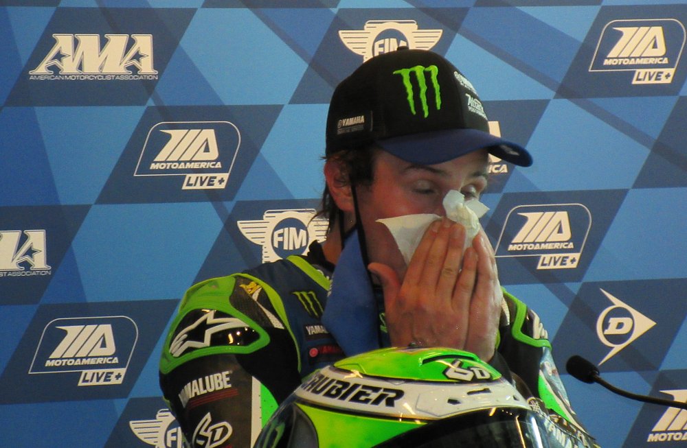 Cameron Beaubier wipes sweat from his face after a race