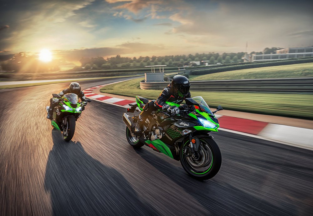 Kawasaki race replicas on track at sunset
