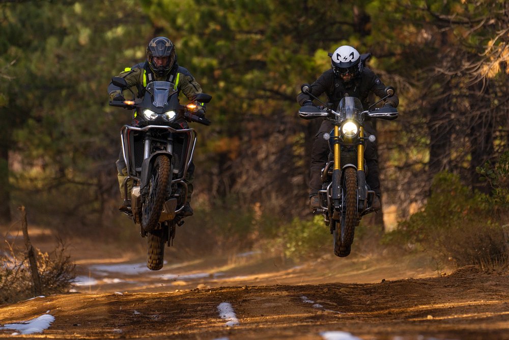 Honda Africa Twin 1100 and Triumph Scrambler 1200 XE jumping.