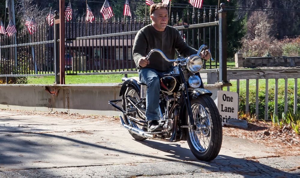 Dale Walksler riding an antique motorcycle
