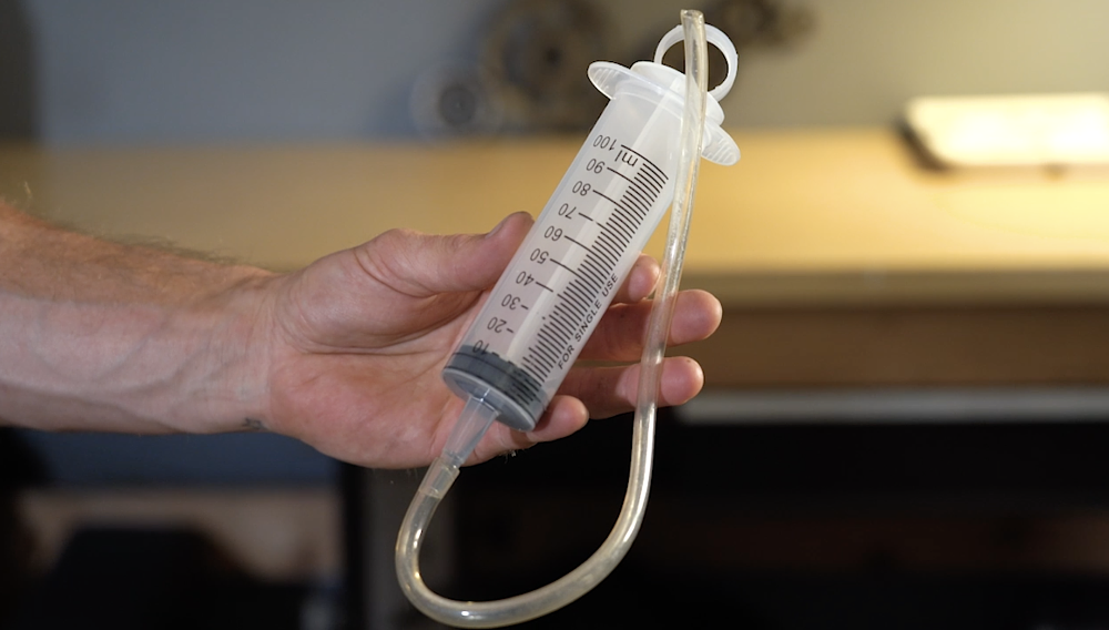 Syringe for removing engine oil.