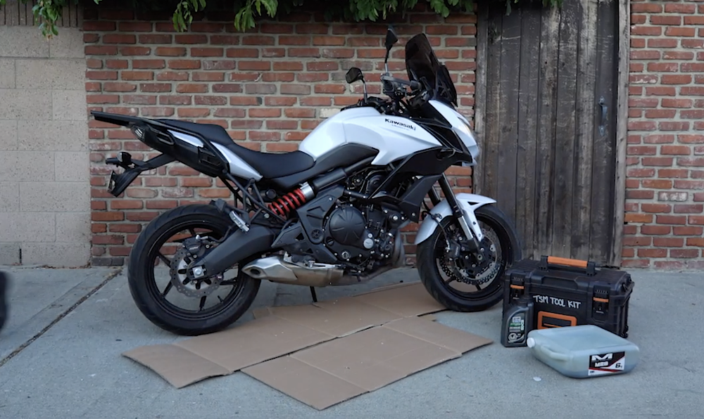 Cardboard on the ground in preparation for an oil change.