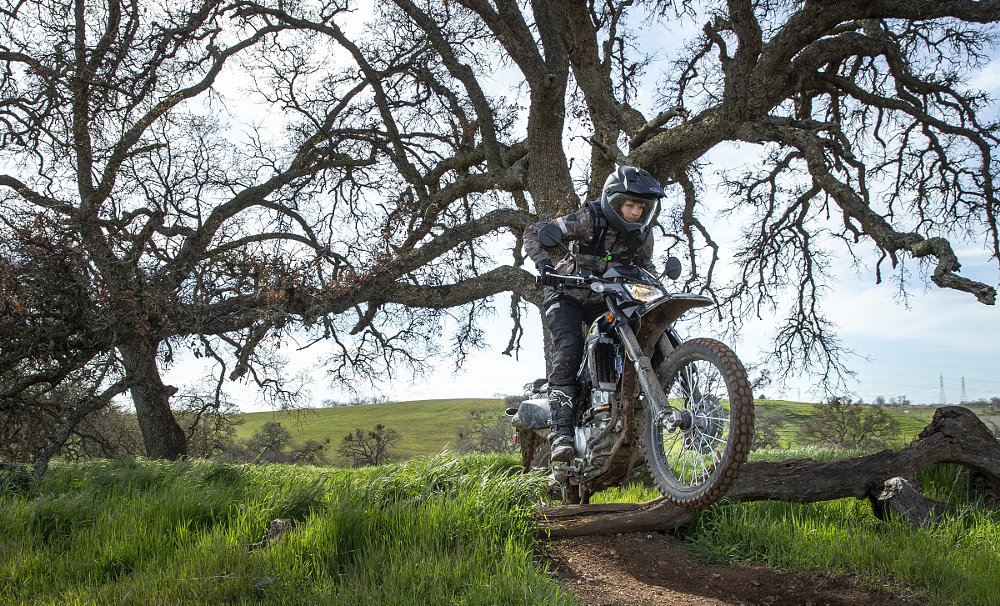 crossing a log on a Kawasaki KLX300