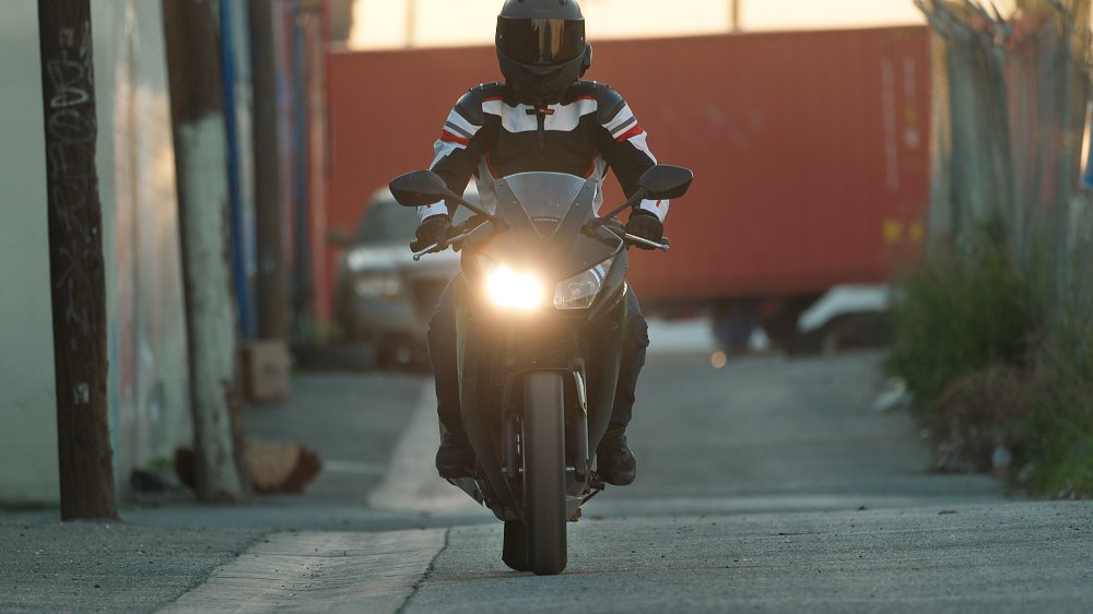 A Honda CBR300R rides toward camera with misaligned wheels