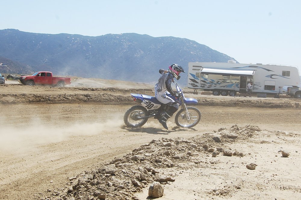 Jen rides the TT-R 125 with speed and dirt flying at the MX track