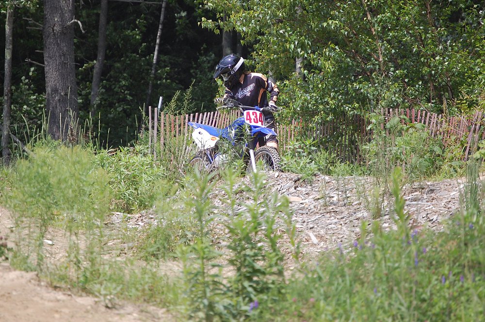 Jen picking up a TT-R 125 dirt bike after dropping it