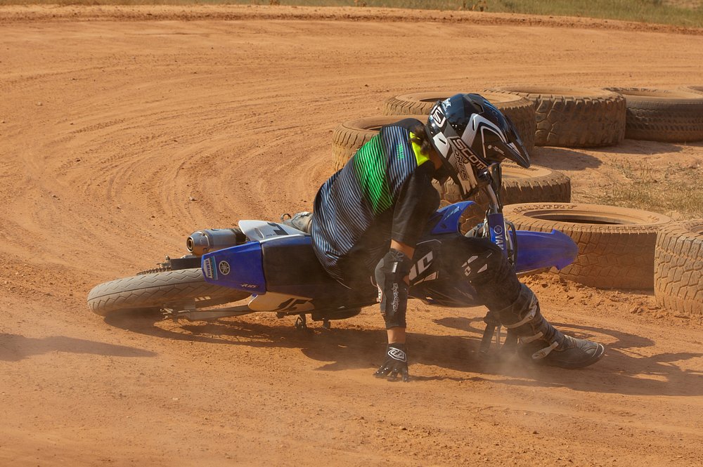 Jen slides out while riding a TT-R 125 in the dirt