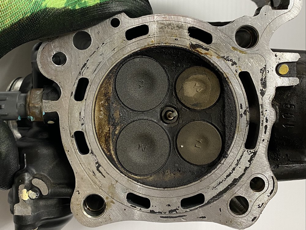 Carbon deposits on a motorcycle cylinder head.
