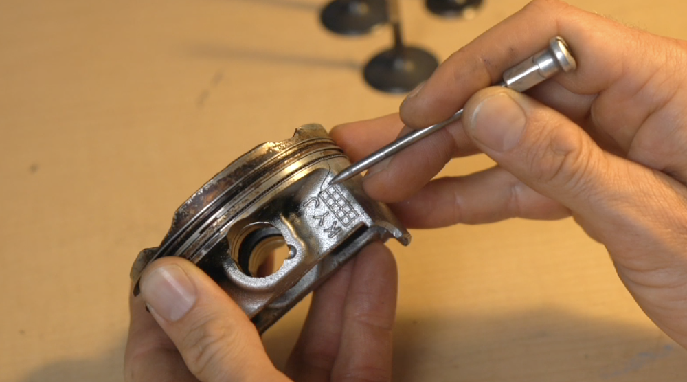 Motorcycle piston damaged due to detonation.