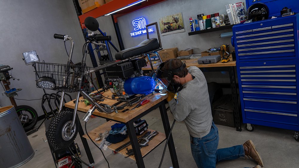 Zack fitting the wheelie bar on the Dumb and Dumber mini bike.