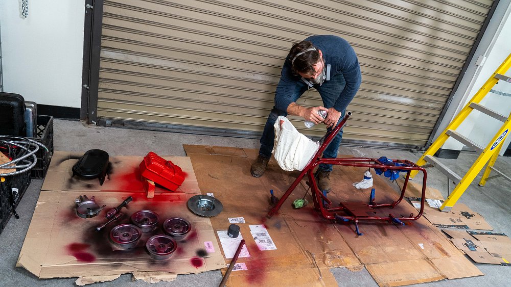 Painting the frame of the Dumb and Dumber mini bike.
