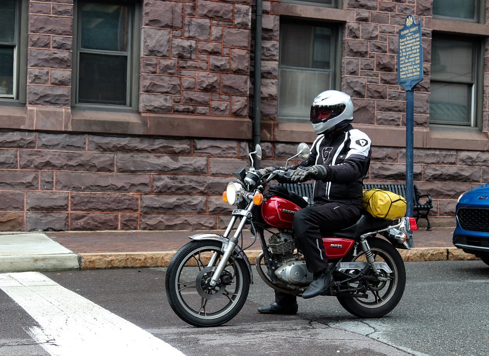 waiting at a stop sign on the GN125