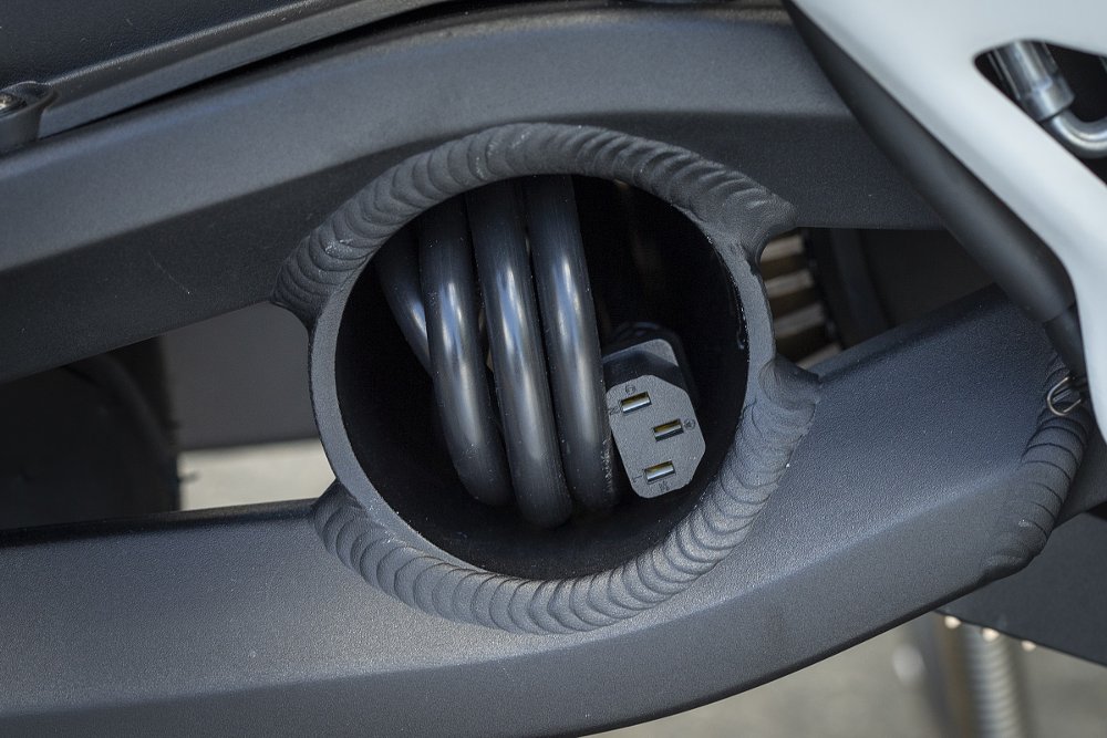 charging cable tucked into swingarm