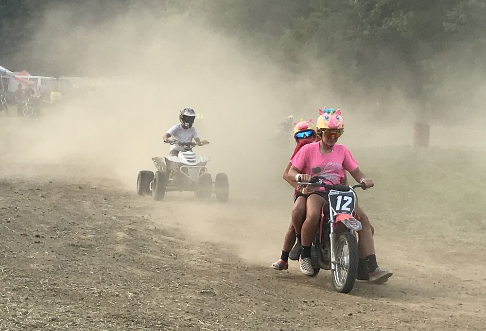 kicking up dust in the campground on little motorcycles