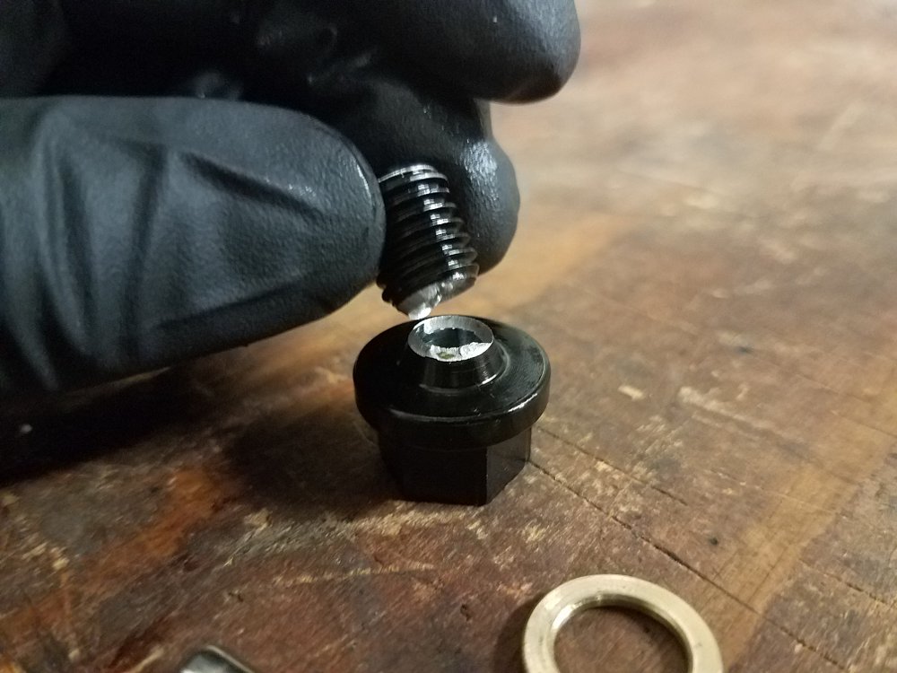 A broken drain plug due to poor quality.