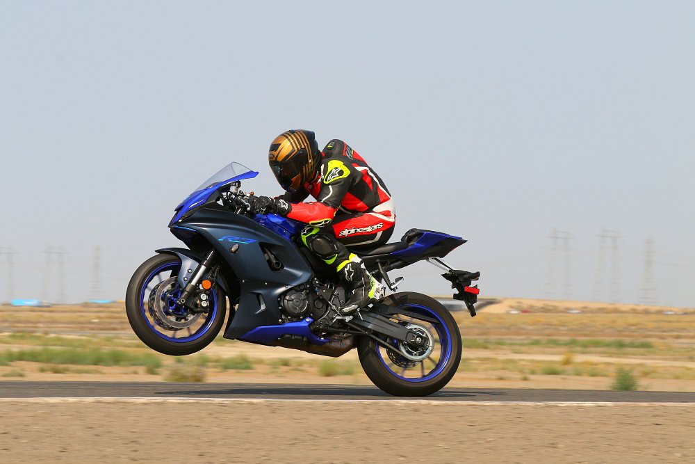 2022 Yamaha R7 profile doing a wheelie on a racetrack