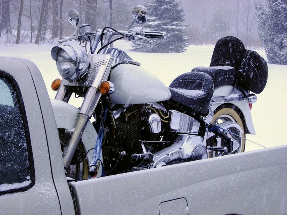 motorcycle in the back of a pickup truck in a snowstorm