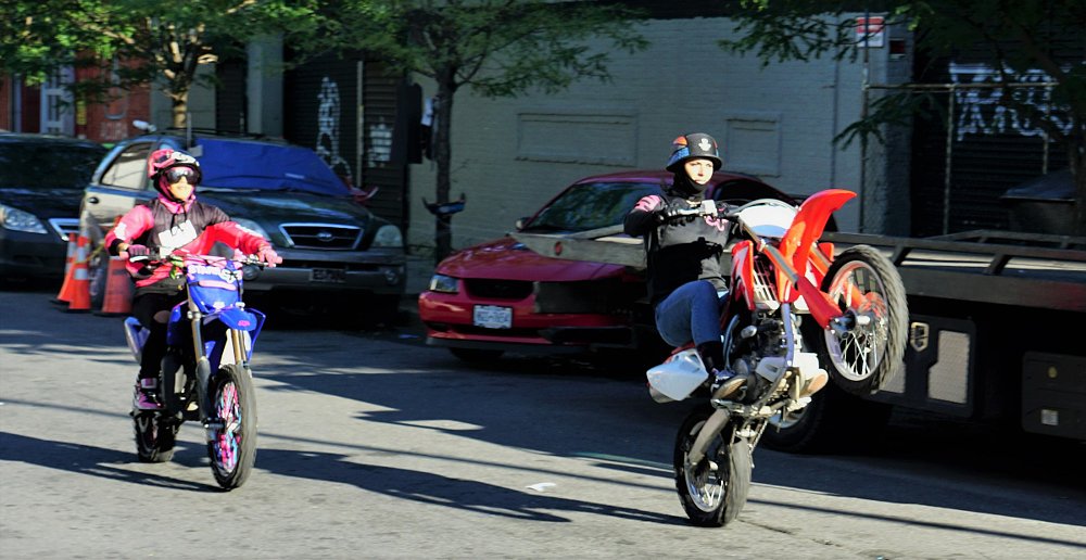 Malissa Alexis doing a wheelie on the street
