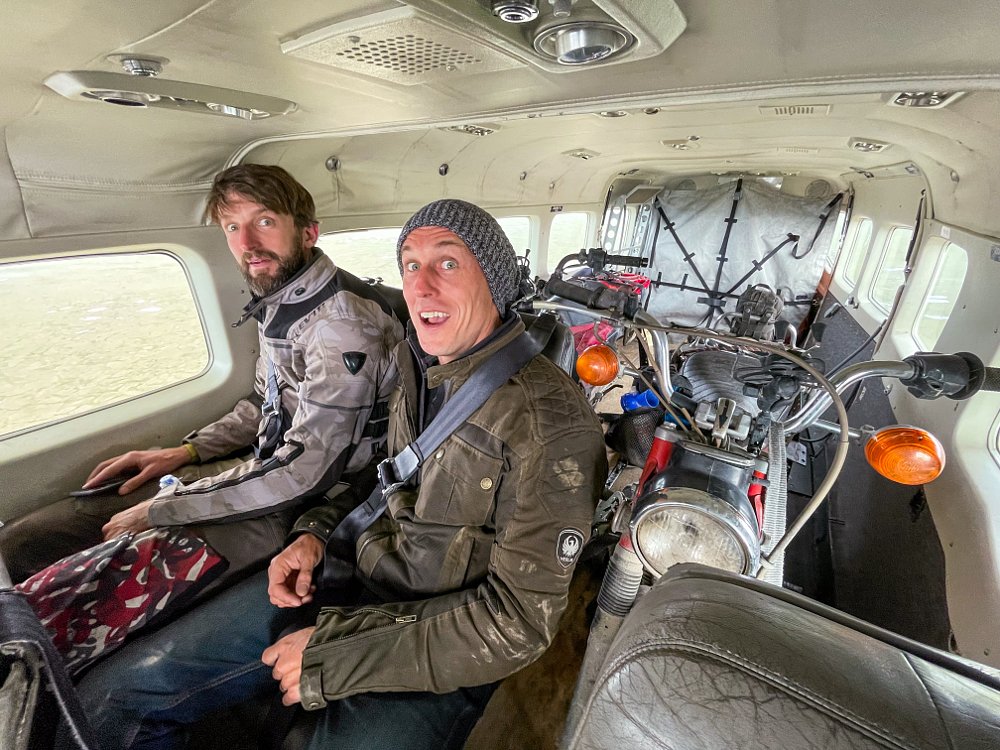 Ari and Zack on a plane with the CT90 and Trail 125.
