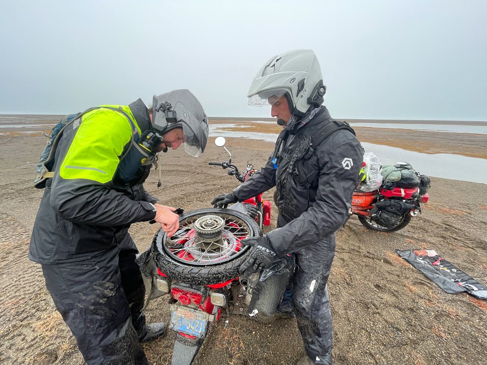 Changing a tube on the Trail 125 on the way to Point Barrow.