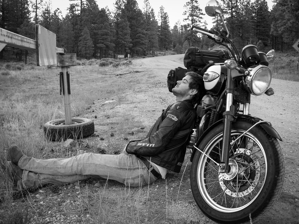 Spurgeon resting at roadside with his Bonneville