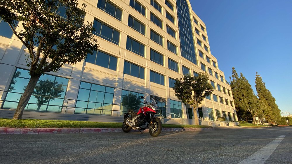 Honda's NC750X parked in front of an office building.