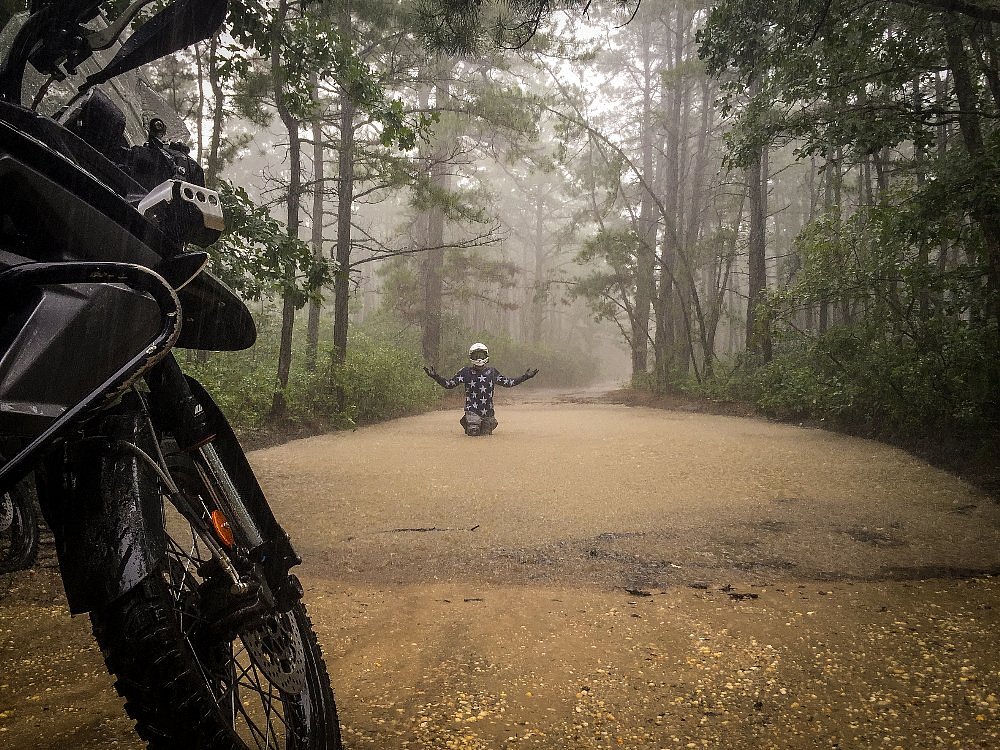 Spurgeon standing in the rain in a deep water crossing
