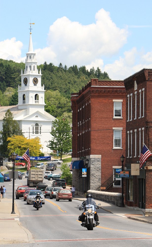 two cruisers riding through a small town in New England