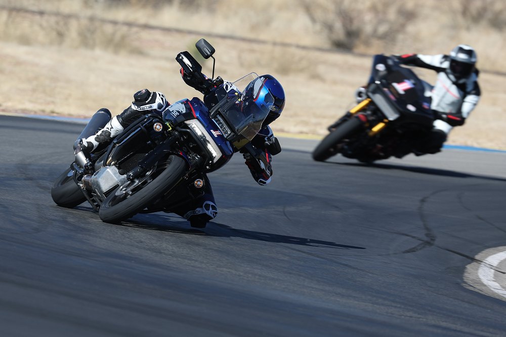 2022 Harley-Davidson Pan America on a race track leading the King of the Baggers Road Glide Special race bike