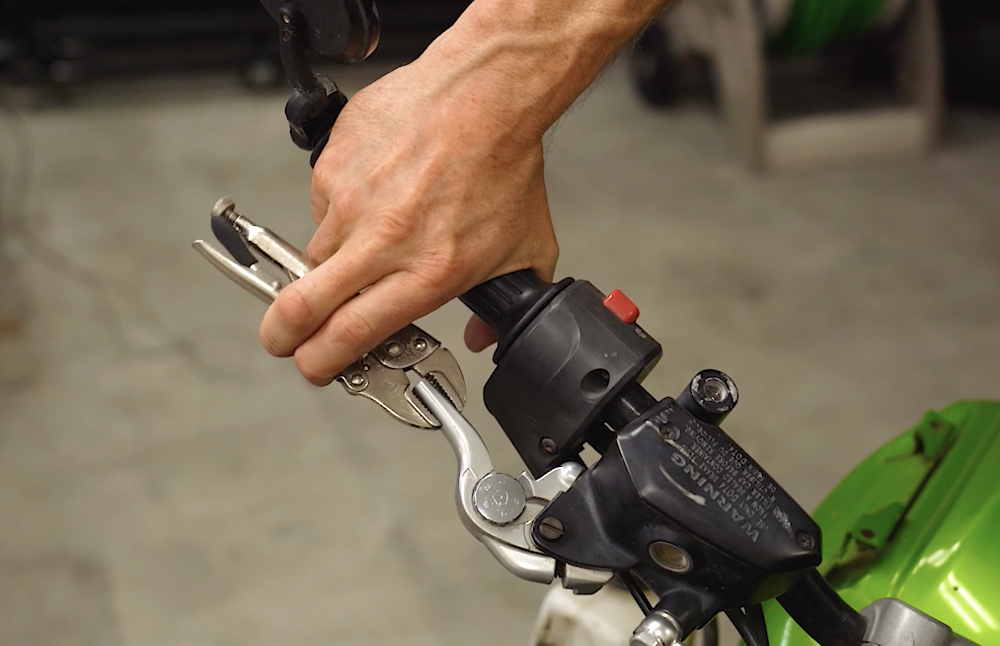 Using vice grips as a brake lever on a motorcycle.