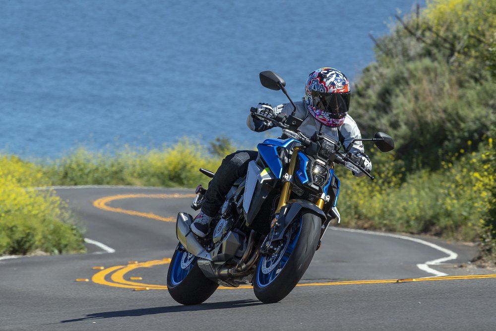 A female rider pilots the GSX-S1000 with the amazing backdrop of ocean and flowers in sunny Malibu California
