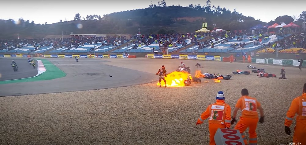 multiple motorcycles crashed on first lap of Moto2 race, one on fire