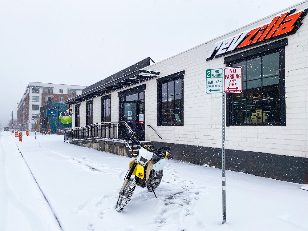 DR-Z400S parked in front of the RevZilla store in the snow