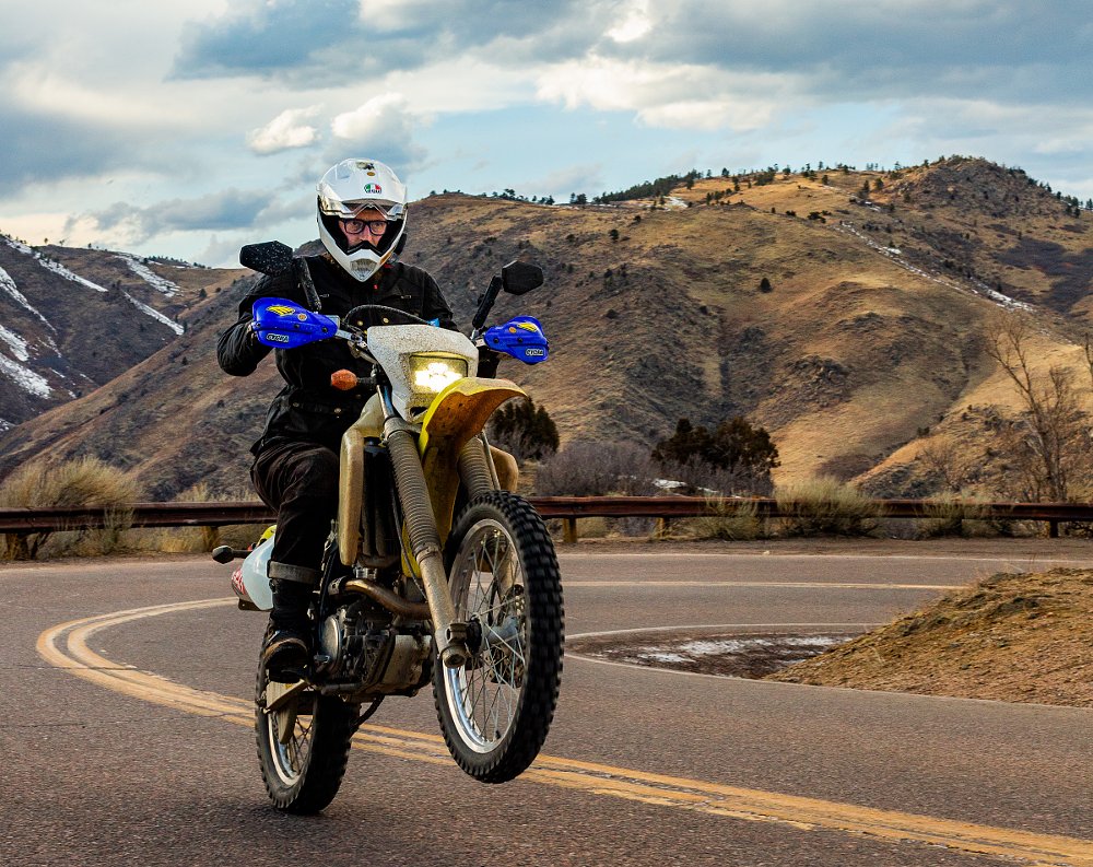 Suzuki DR-Z400S doing a wheelie on the road