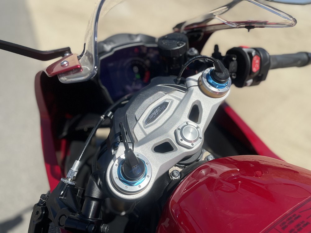 A close up view of the Öhlins EC 2.0 smart electronic suspension sensors on the front fork of the motorcycle